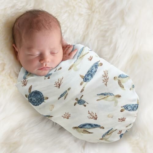 Sleeping baby swaddled in a sea turtle patterned blanket.