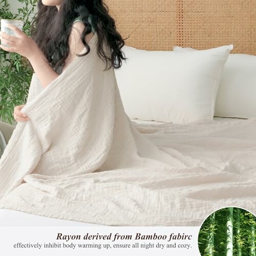 Person wrapped in bamboo fabric on a bed with greenery.