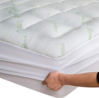 Person adjusting a bamboo mattress protector