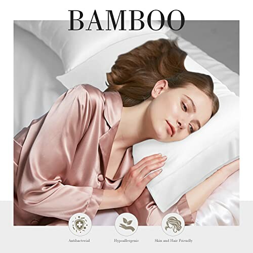 Woman in silk pajamas resting on bamboo pillowcase.