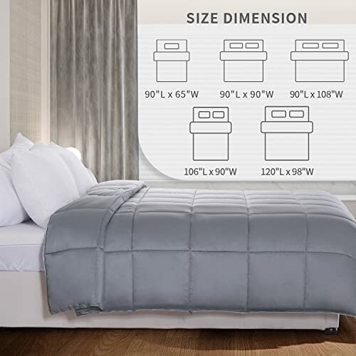 Bed with gray comforter and size dimension chart on wall.