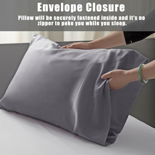 Hands adjusting pillow with envelope closure design.