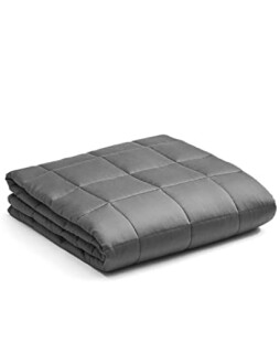 Folded gray weighted blanket on white background