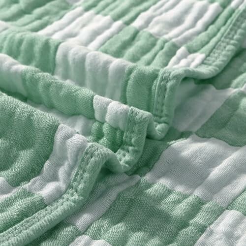 Close-up of green and white quilted fabric texture