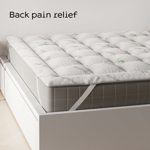 Mattress topper on bed for back pain relief.