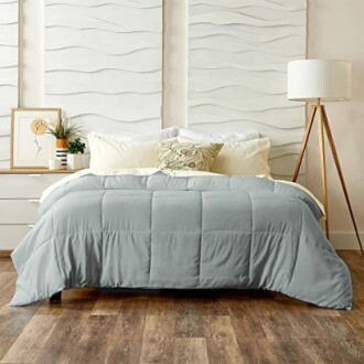 Contemporary bedroom with a grey comforter, pillows, and decor.