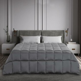 Modern bedroom with gray bedding and upholstered headboard