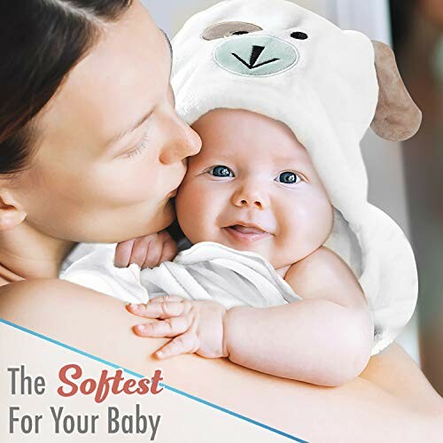 Mother holding smiling baby wrapped in a soft towel with a bear hood.