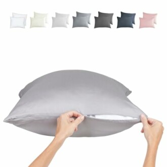 Hands holding a gray silk pillowcase with various colors displayed above.