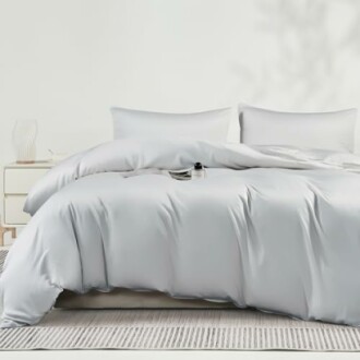 White bedding set with pillows on a bed.