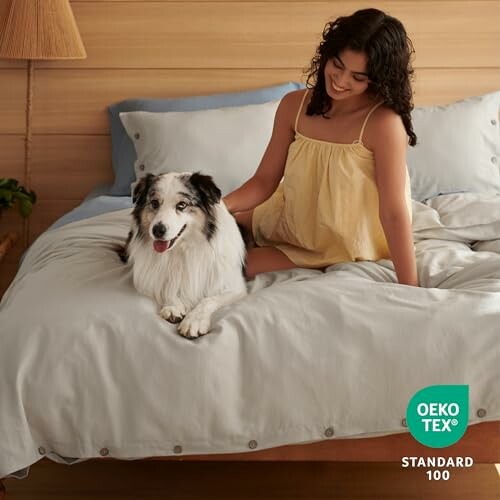 Woman sitting on a bed with a dog, Oeko-Tex Standard 100 label visible.