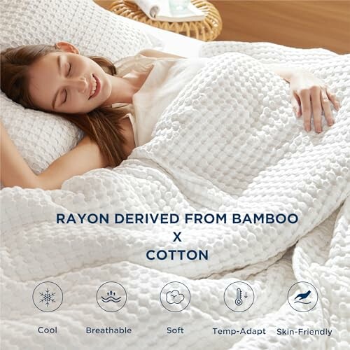 Woman sleeping under a bamboo cotton blanket with comfort features listed.